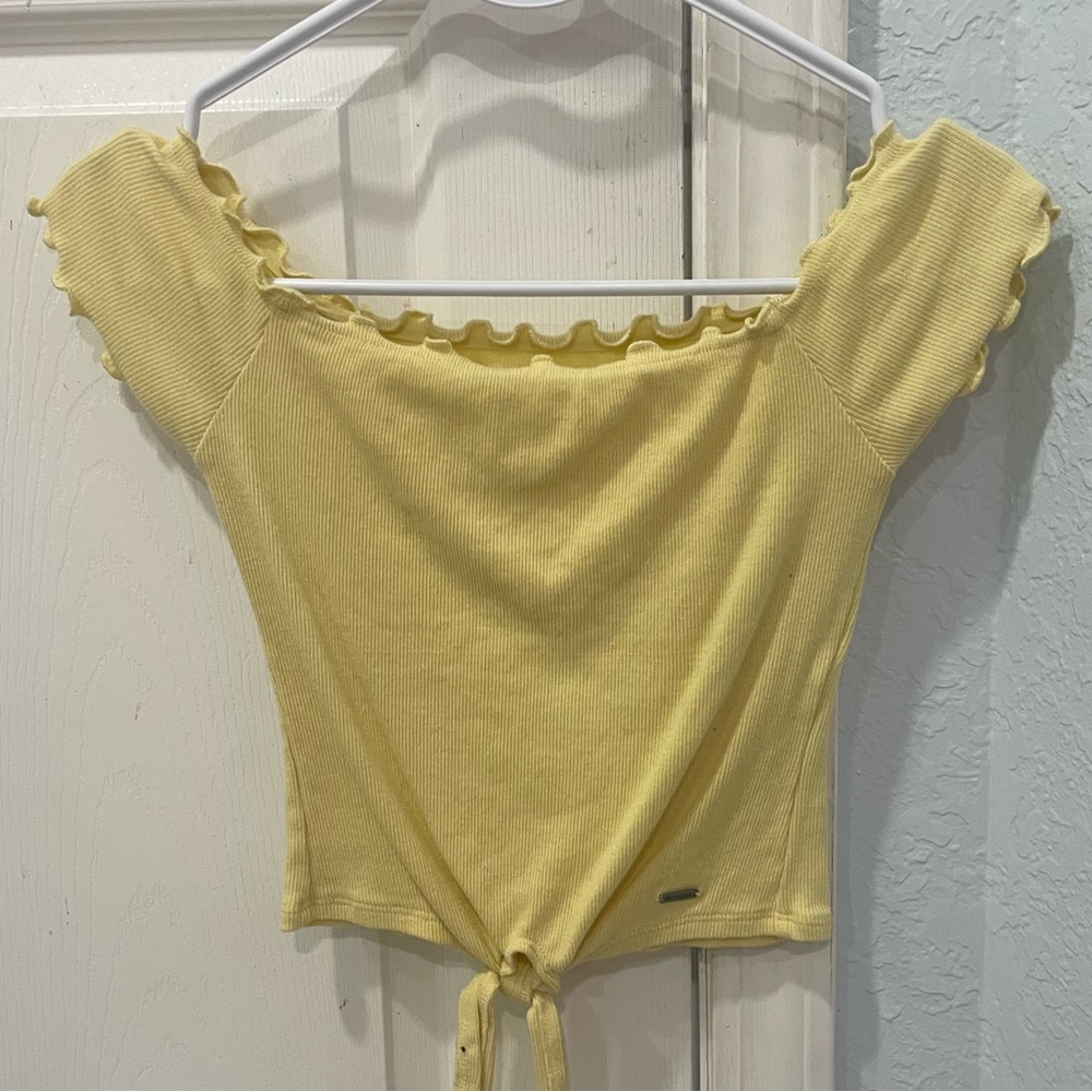Yellow hollister low cut shirt with on or off the shoulder sleeves.